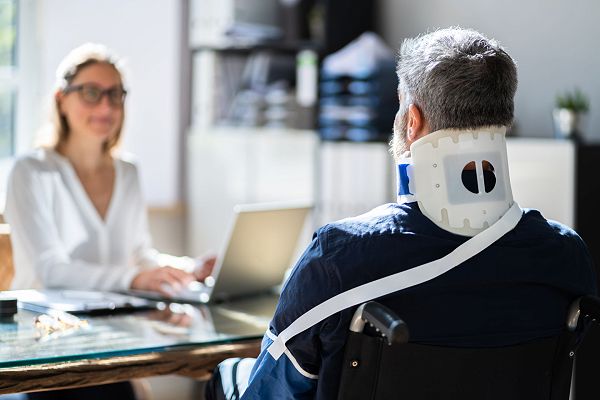 Solicitor with client wearing a neck brace